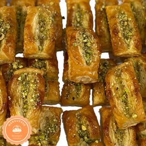 Golden brown Zaban pastries with a glossy syrup and sprinkled with pistachios