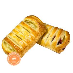 Close-up of a Danish pastry with flaky layers and fruit filling